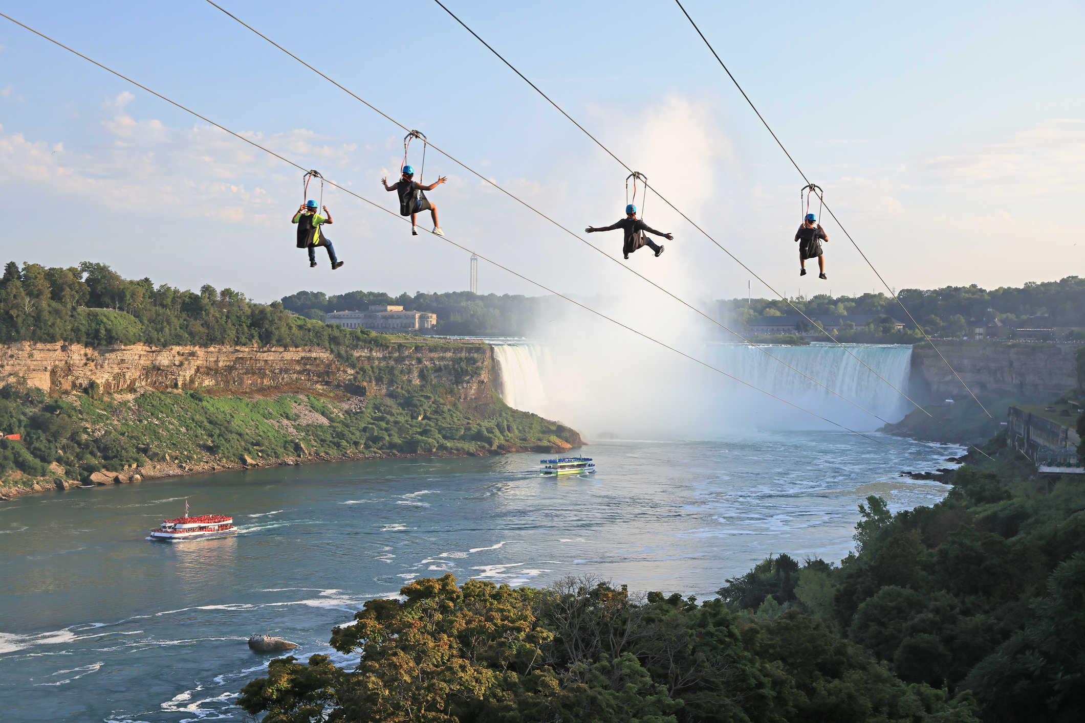 4 riders at the zipline to the falls tour.
