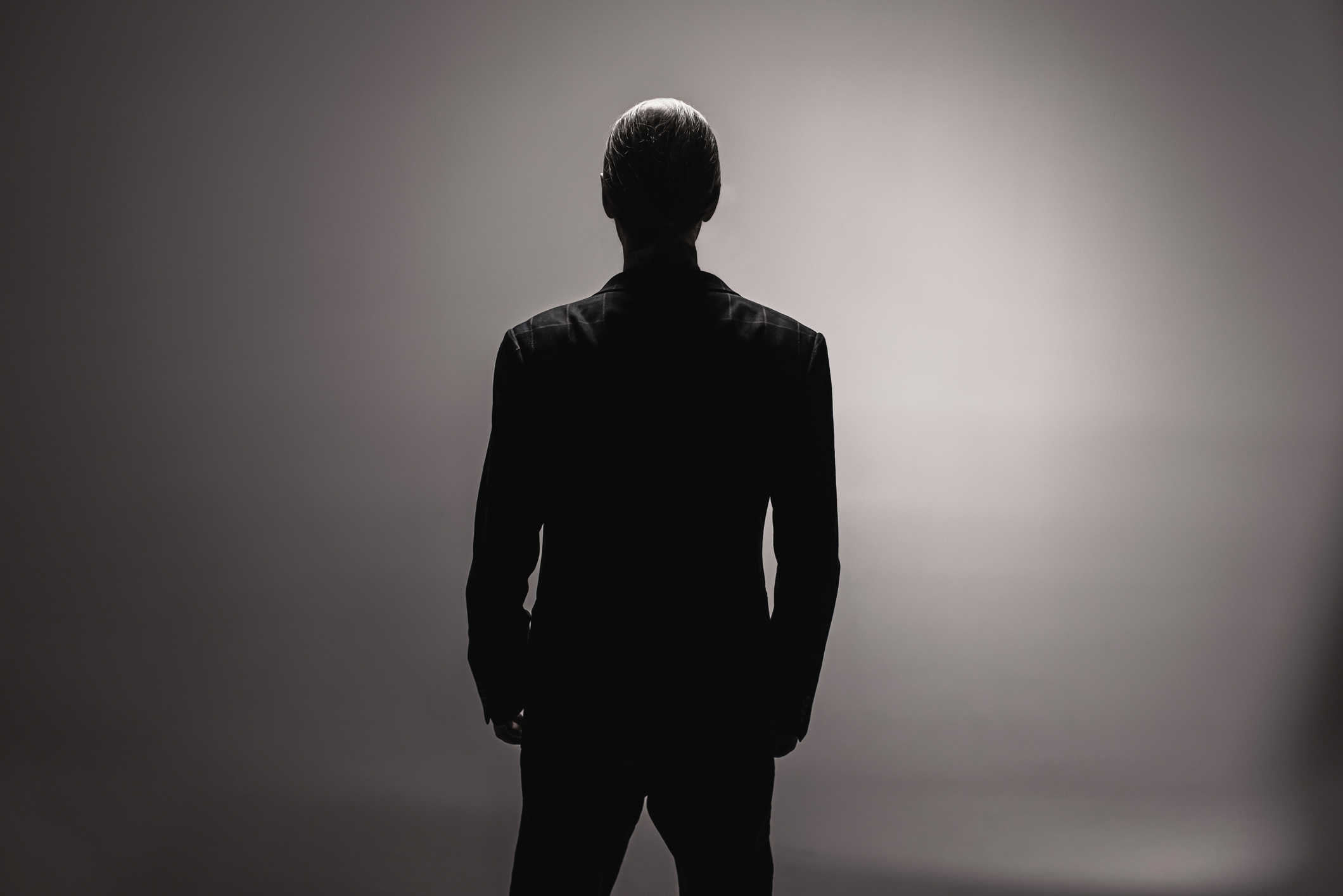 Silhouette of a man in total darkness
