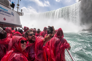Tourists on Niagara City Cruises Voyage to the Falls boat surrounded by mist from Horseshoe Falls