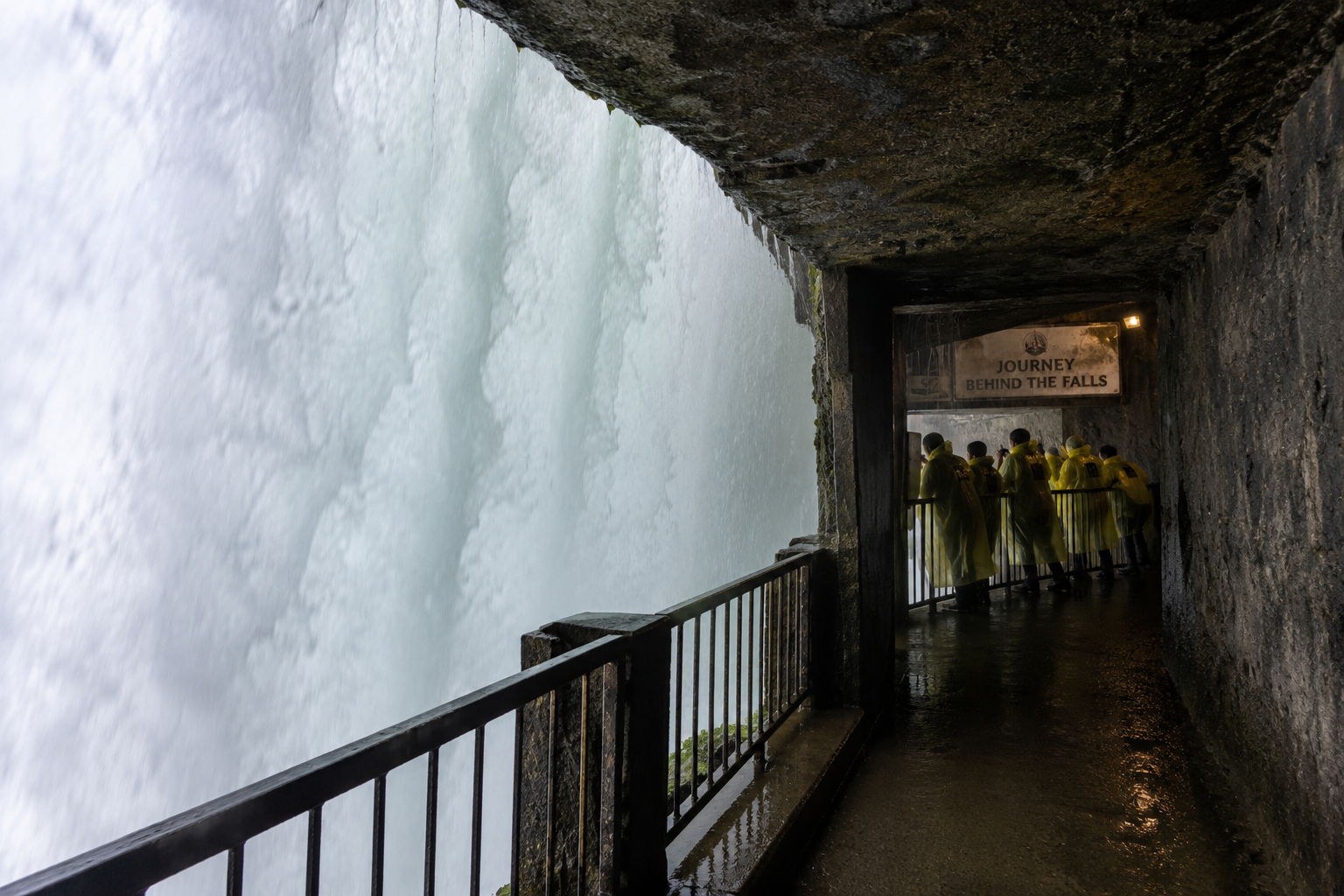 View from Journey Behind the Falls observation tunnel showing powerful water curtain at Horseshoe Falls