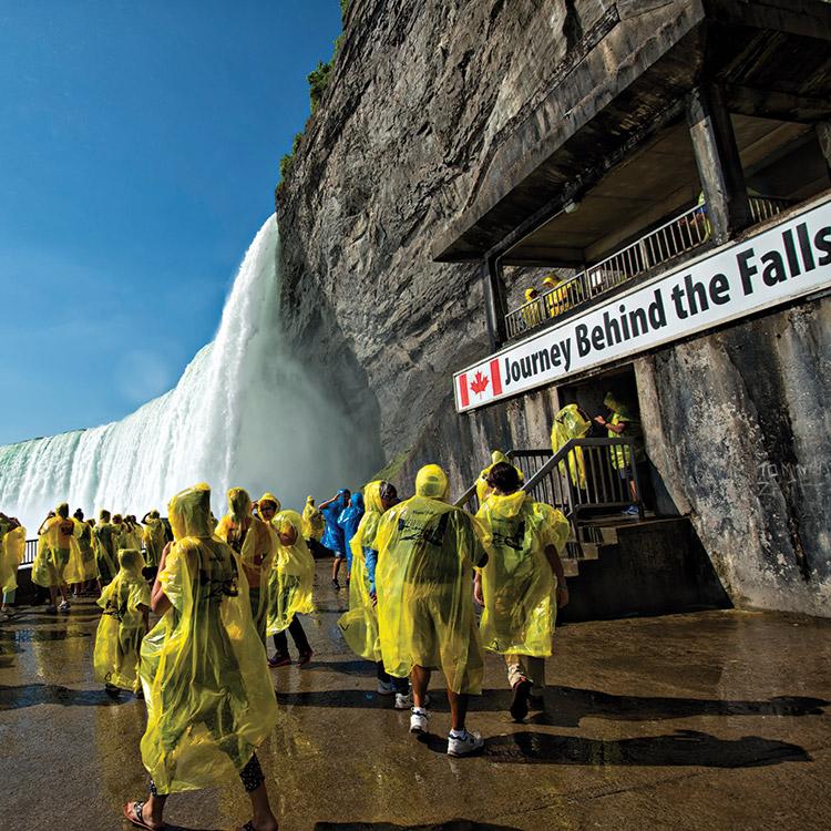 Visitors walking through the Journey Behind the Falls tunnels at Niagara Falls.